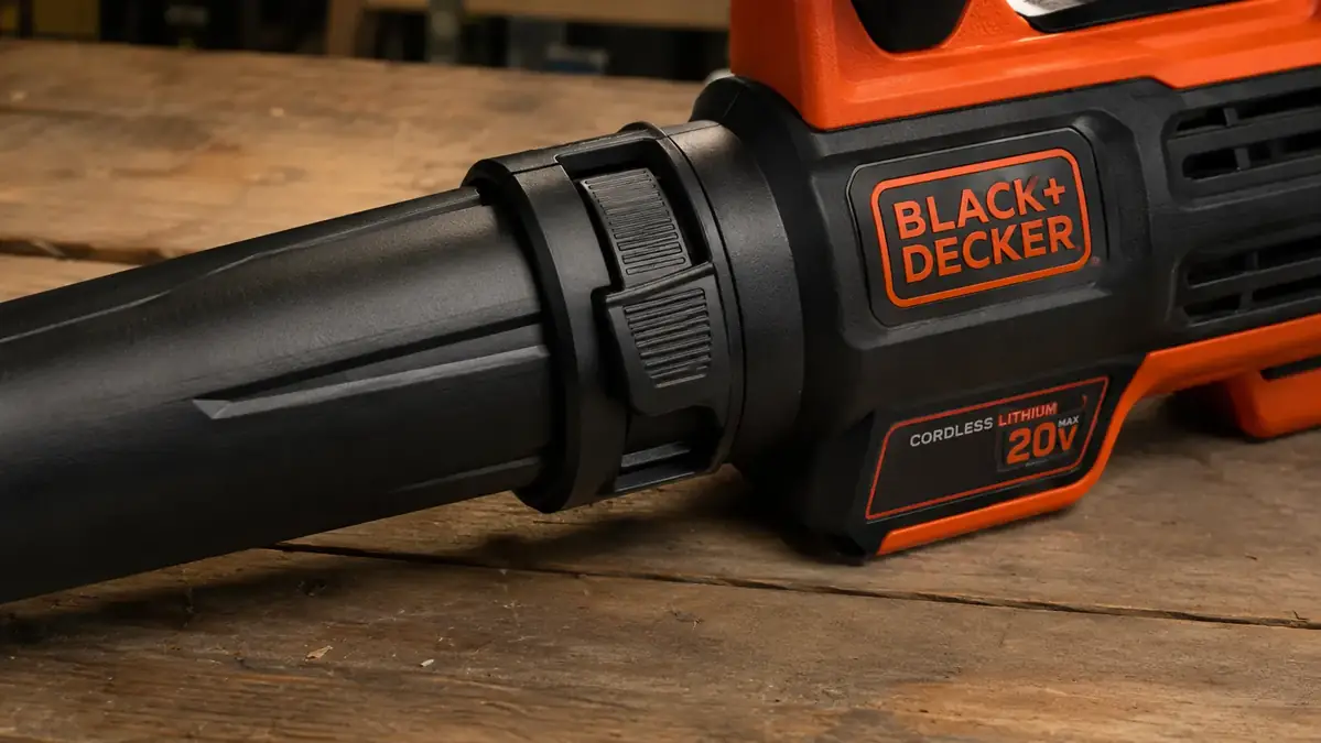 Close-up of a small crack near the nozzle clip of the cordless leaf blower resting on a workbench